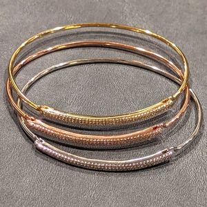 Set of 3 cubic zirconia gold, rose gold, and rhodium plated bangle.
